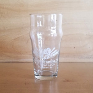 Tractor 16 ounce pub glass with white logo