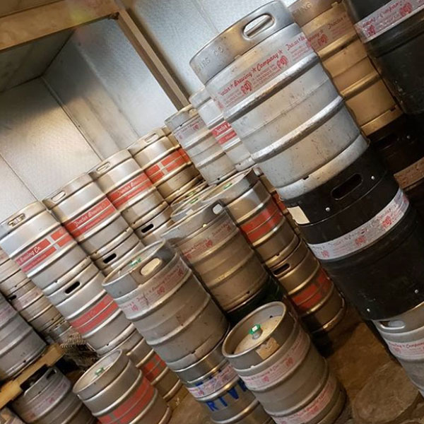 Stacked kegs in a large fridge