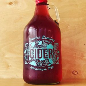 Clear Glass growler with Tractor Brewing Cider Albuquerque NM in turquoise